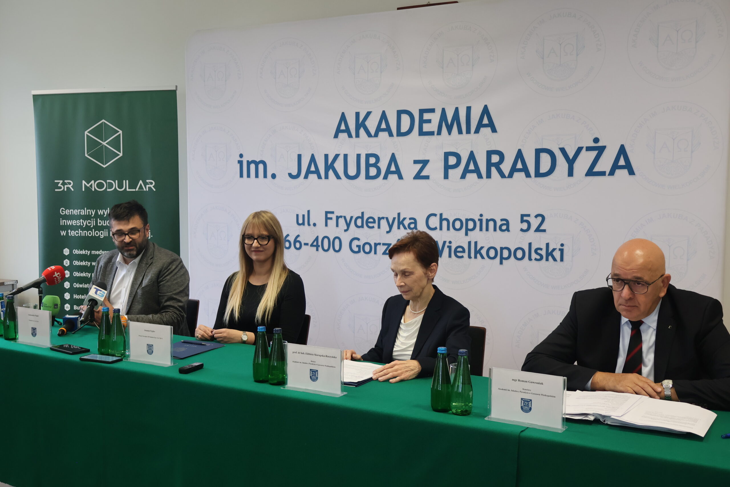 Na zdjęciu od prawej za stołem: mgr Roman Gawroniak, Rektor Akademii im. Jakuba z Paradyża - prof. dr hab. Elżbieta Skorupska-Raczyńska, Prezes Zarządu Wykonawcy 3R MODULAR Pani Joanna Sypko,Przedstawiciel firmy CLIMATIC Pan Aleksander Panek podczas podpisania umowy o budowę nowego budynku 3bis na terenie przy ul. Fryderyka Chopina 52. ,Przedstawiciel firmy CLIMATIC Pan Aleksander Panek wypowiada się do mediów.