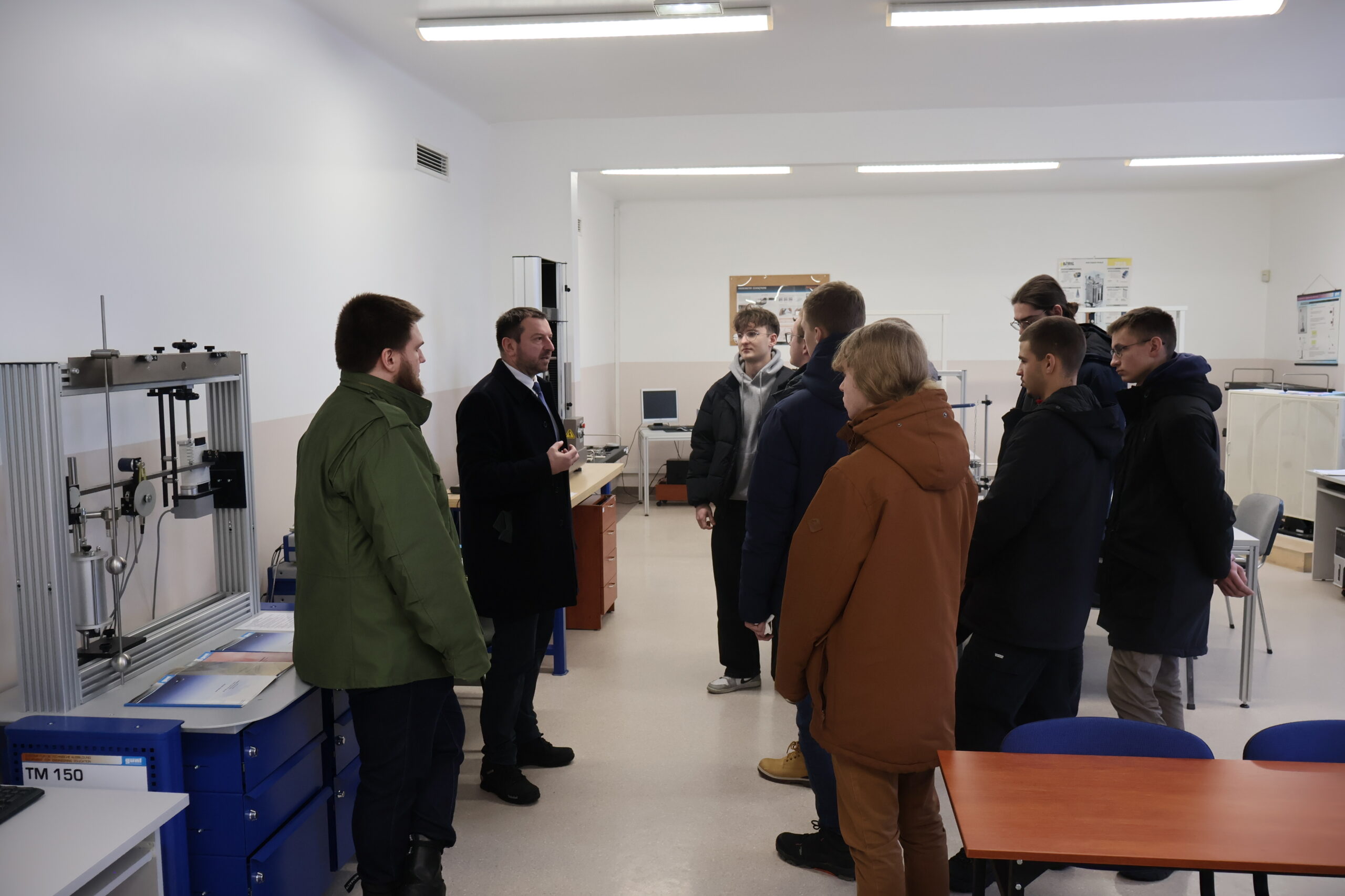 Grupa osób podczas zwiedzania laboratorium.